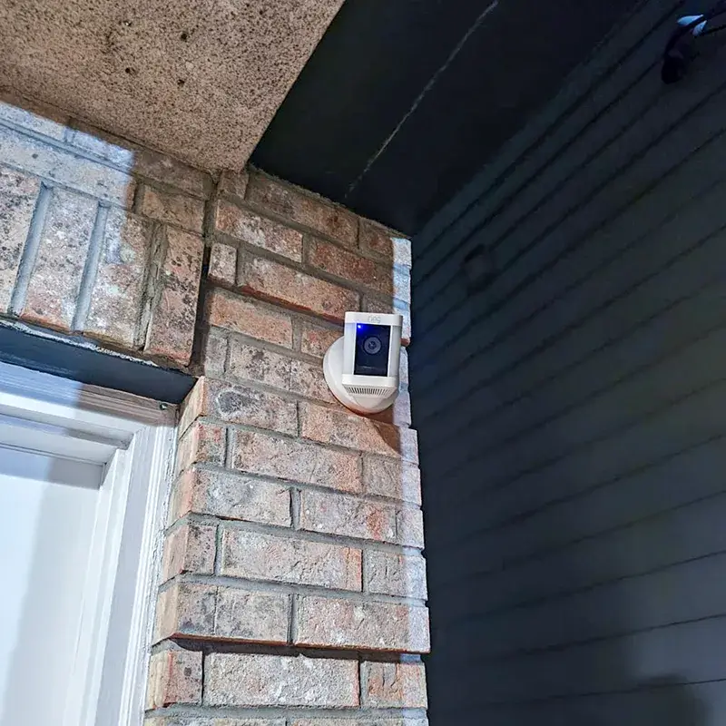 Security camera professionally installed on brick exterior wall in New Jersey
